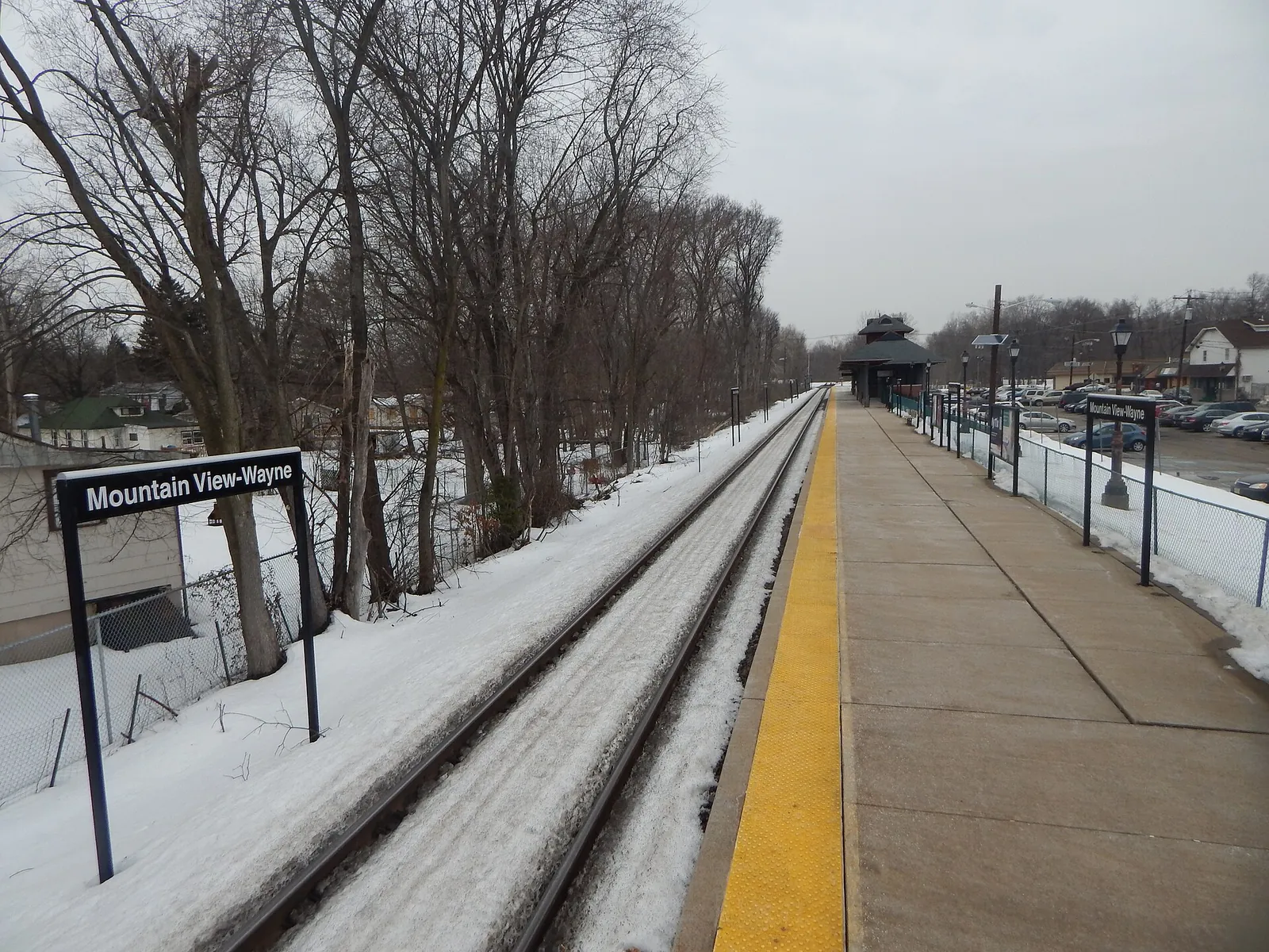 Snow along the tracks at the Mountain View-Wayne train station platform in winter